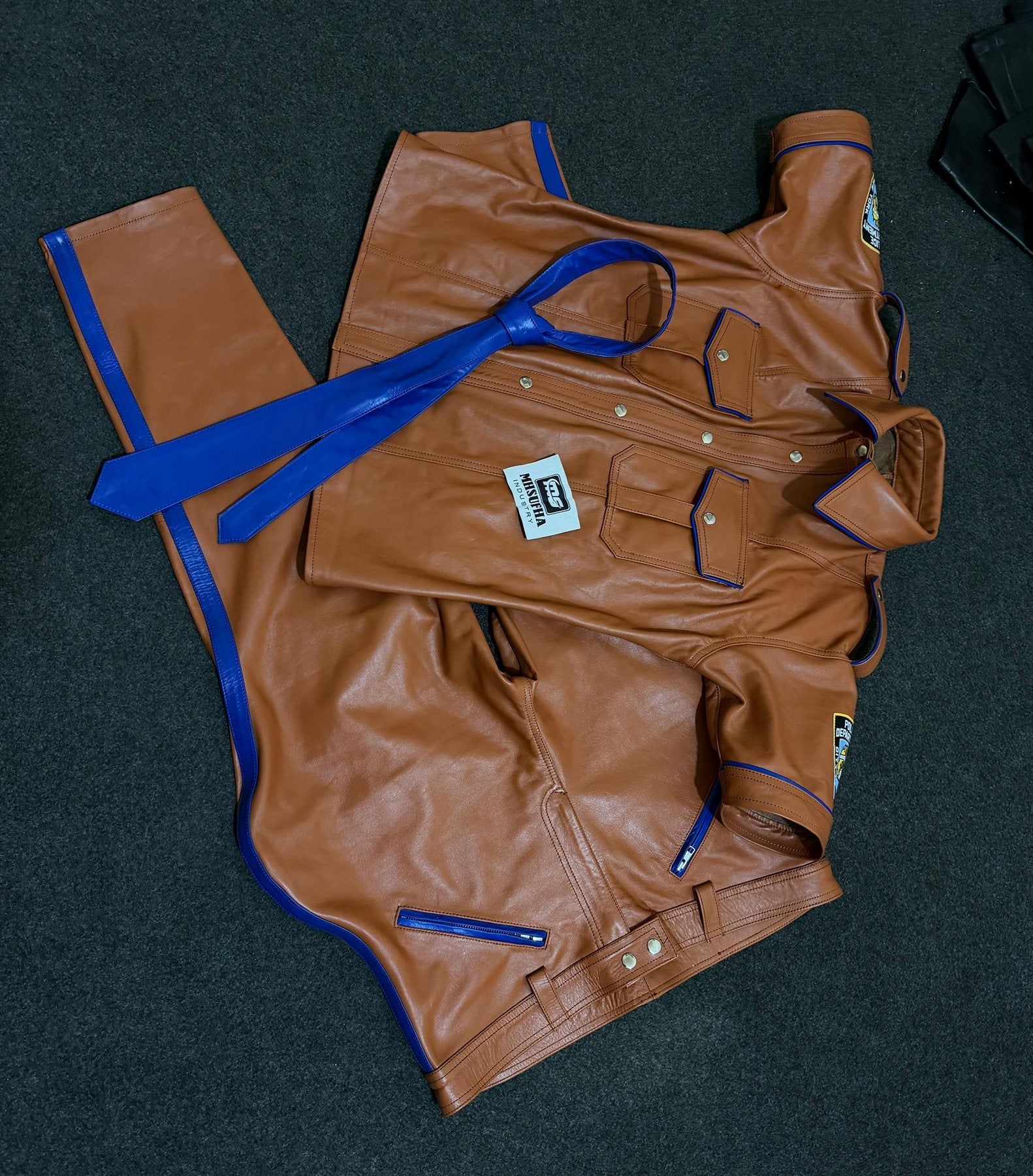 Tan leather uniform trousers with blue piped seams