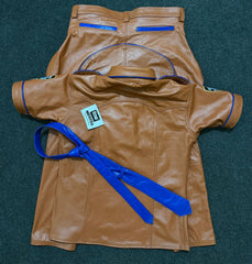 Close view of tan leather uniform shirt collar, epaulettes and blue piping