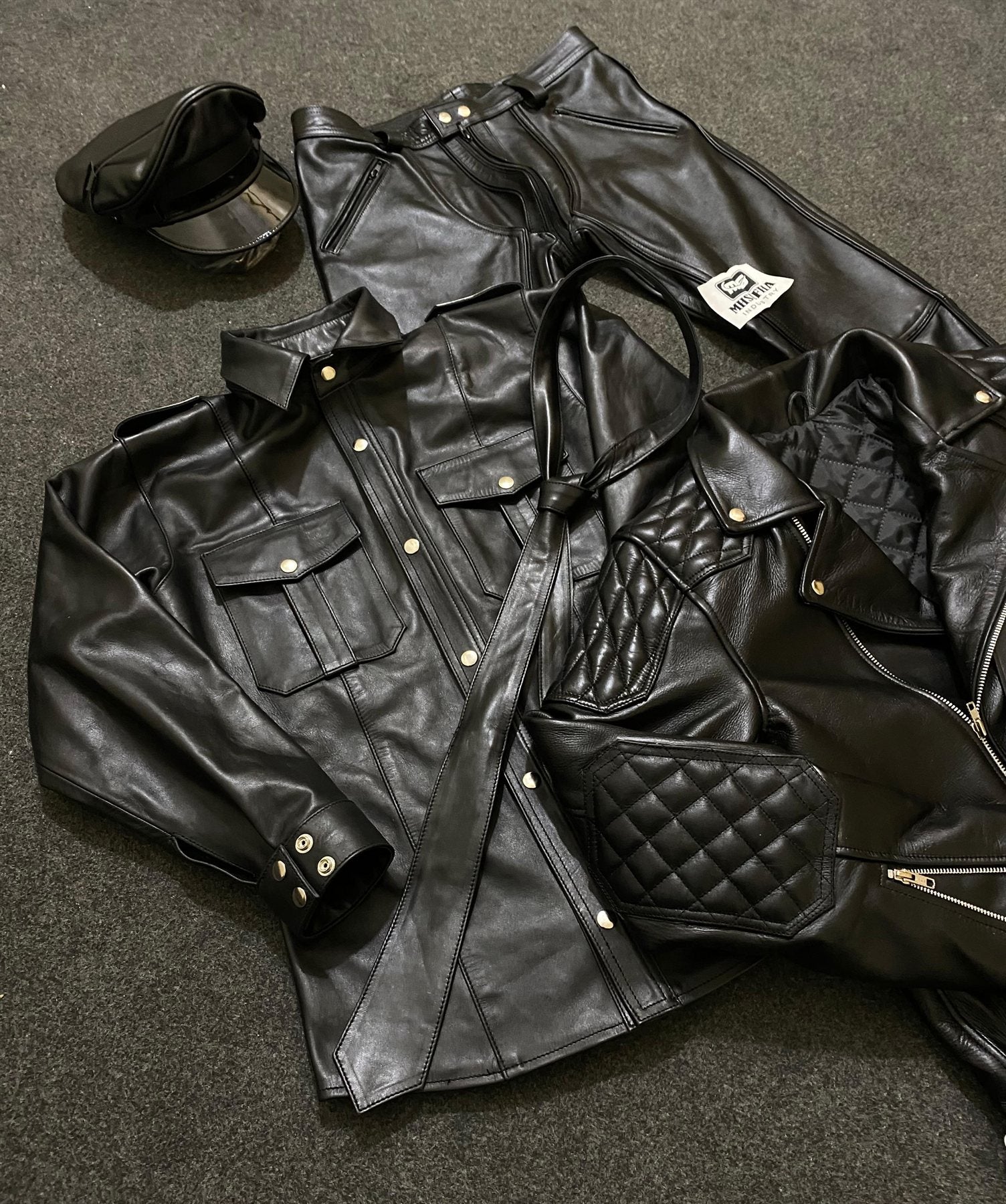 Black leather uniform shirt and trousers with peaked cap and quilted jacket