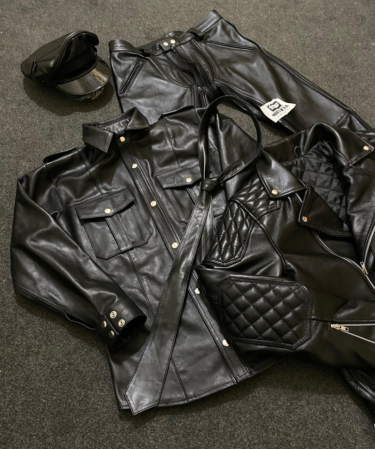 Black leather uniform shirt and trousers with peaked cap and quilted jacket
